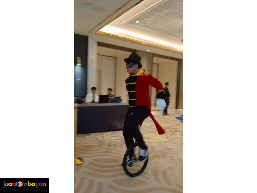 Unicyclist roaming around performers for Family day 
