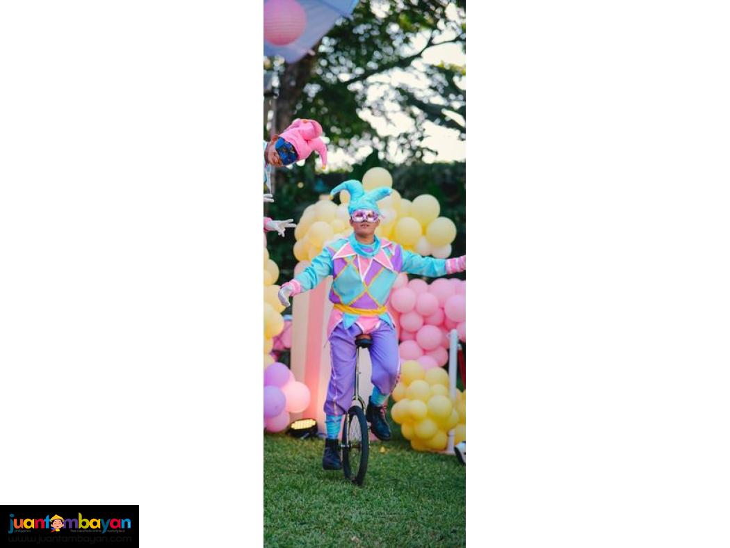 Unicyclist roaming around performers for Family day 